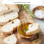 Homemade Italian Bread recipe; a sliced loaf of homemade Italian bread on a wooden serving platter.