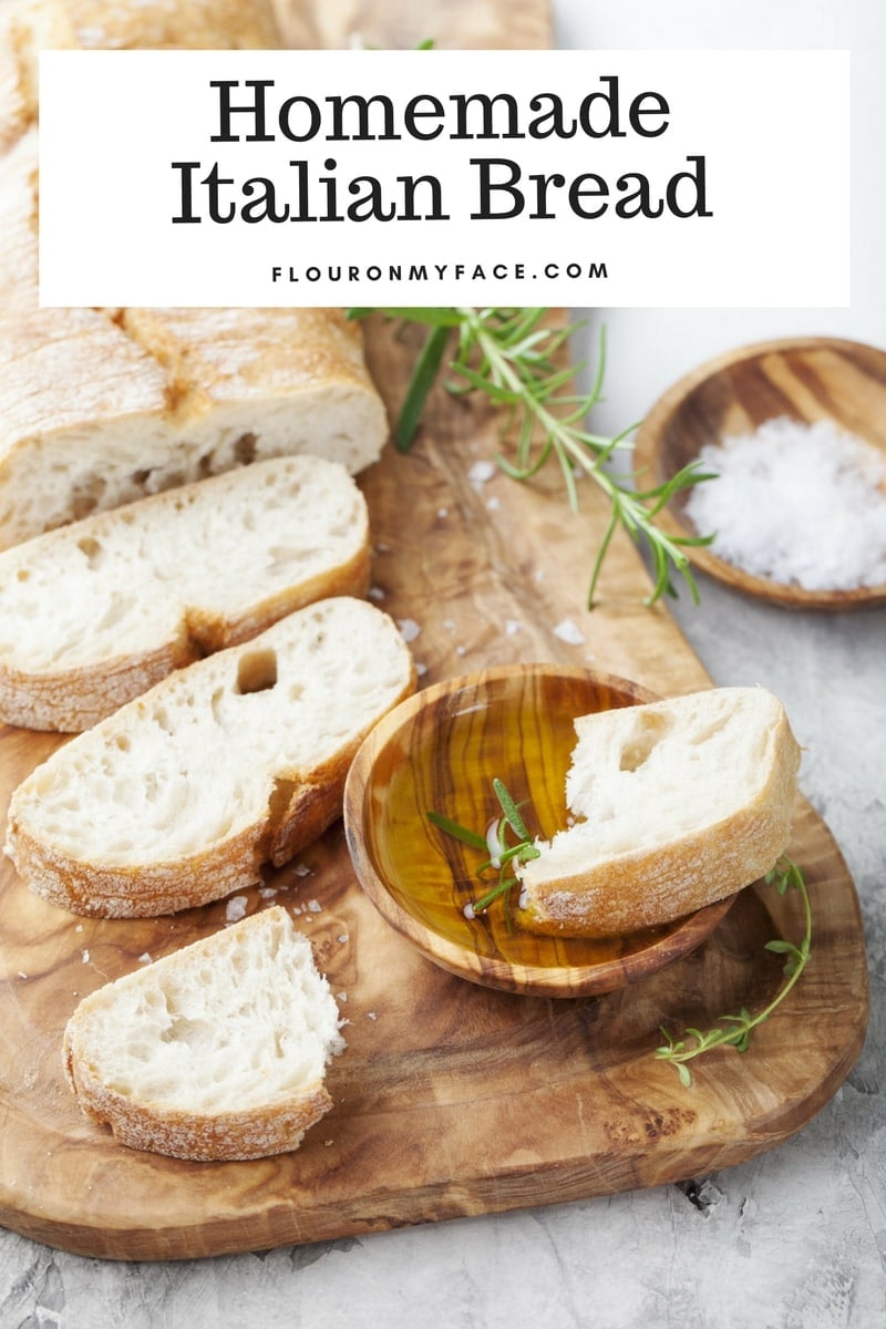 Homemade Italian Bread recipe; a sliced loaf of homemade Italian bread on a wooden serving platter.