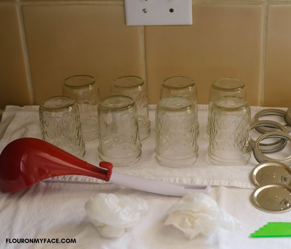 A canning station set up before starting with prepped jars and tools needed.