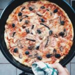 Single Serve Deep Dish Pizza served in a cast iron pan.