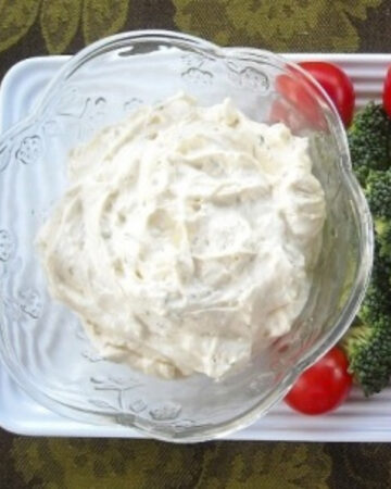 a bowl of ranch veggie dip served with fresh vegetables