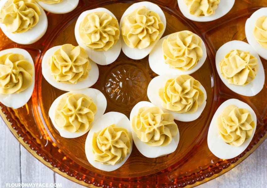Tangy Deviled Eggs on a brown glass holiday Deviled Eggs plate
