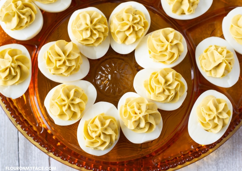 Tangy Deviled Eggs on a brown glass holiday Deviled Eggs plate