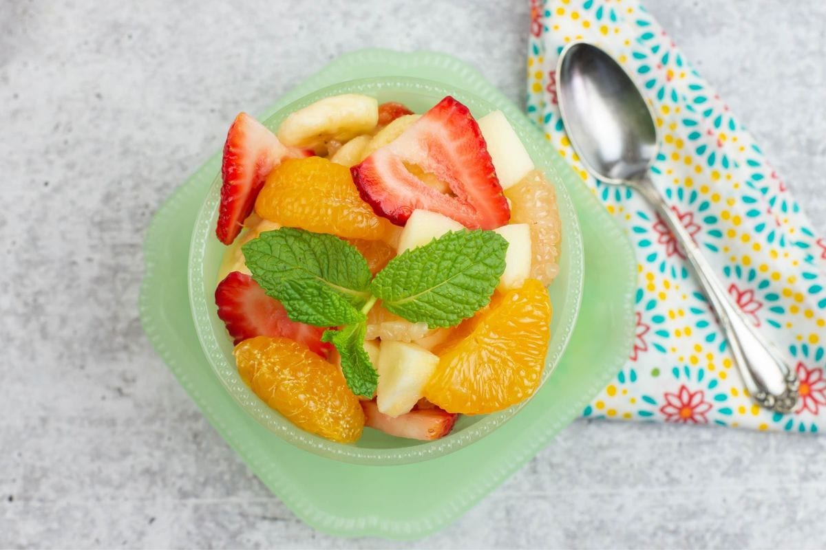 Fruit Salad recipe served in a green bowl.