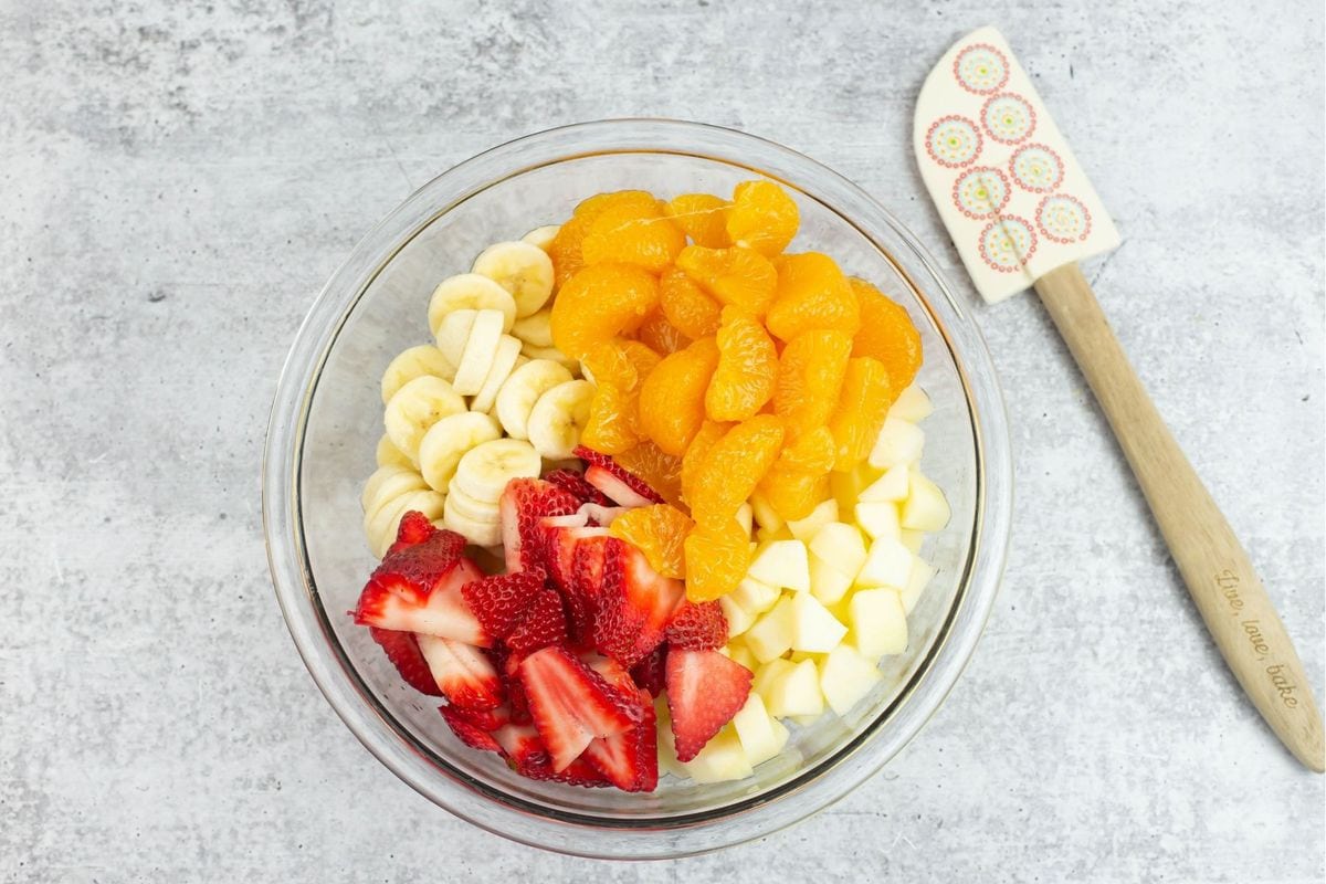Sliced and cubed fruit in a bowl.