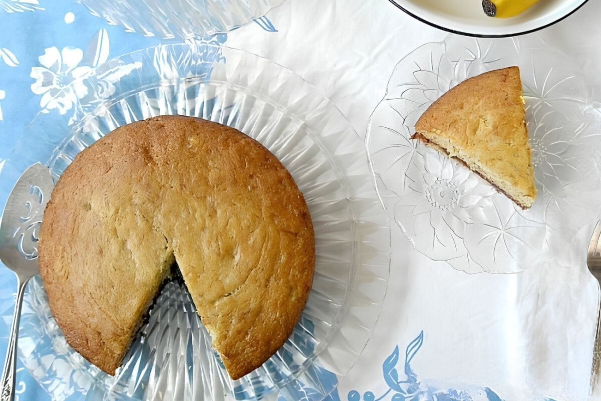 Banana Cake with wedge cut out and slice on plate.