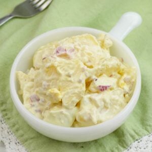 Closeup photo of a single serving bowl of potato salad.
