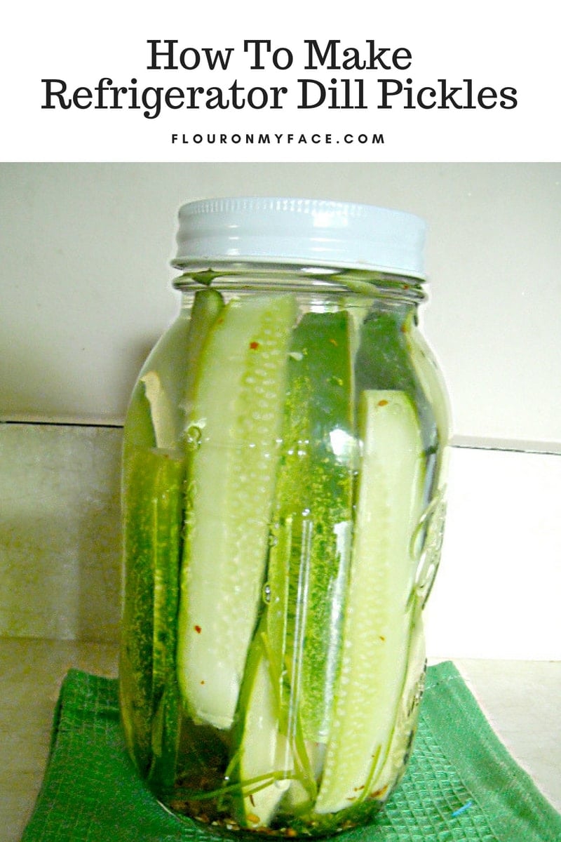 Homemade refrigerator dill pickles in a quart canning jar made from homegrown Kirby cucumbers