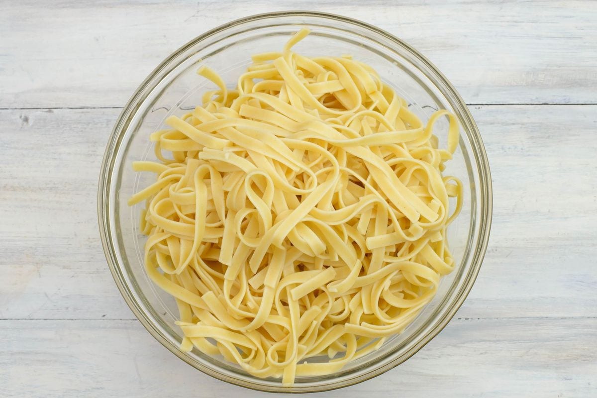 Cooked and drained fettuccine noodles in a bowl.