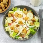 A salad bowl with a mixed salad topped with homemade croutons.