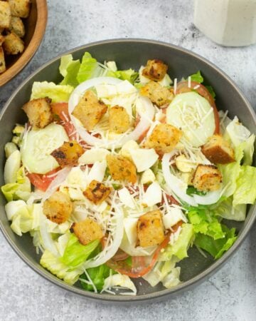 A salad bowl with a mixed salad topped with homemade croutons.