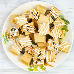 White Chocolate Pumpkin Fudge Squares decorated with sprinkles on a Fall serving plate