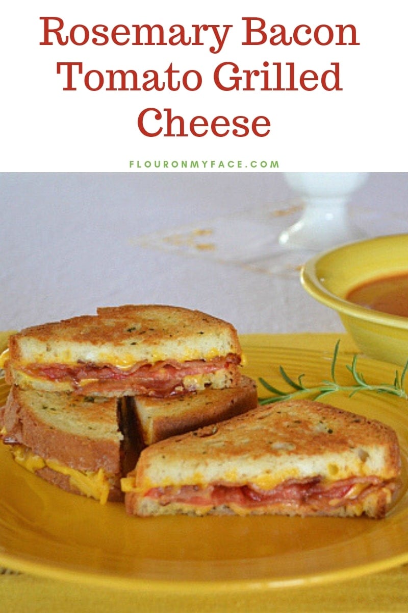 Rosemary Bacon Tomato Grilled Cheese Sandwich stacked on a yellow plate served with tomato soup