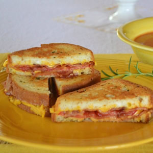 Rosemary Bacon Tomato Grilled Cheese Sandwich on a plate.