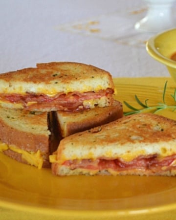 Rosemary Bacon Tomato Grilled Cheese Sandwich on a plate.