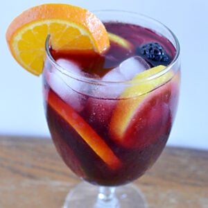 a wine glass filled with Sangria and fruit