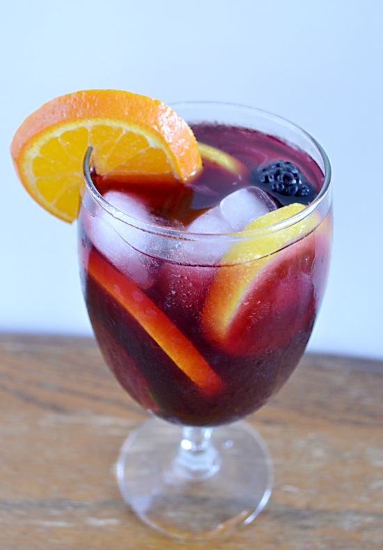 a wine glass filled with Sangria and fruit