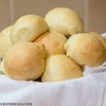 No Knead Slider Buns in a bread basket.