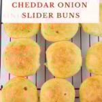 Fresh baked slider buns on a cooling rack.