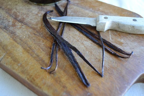 Split the vanilla beans down the center leaving them connected at one end.