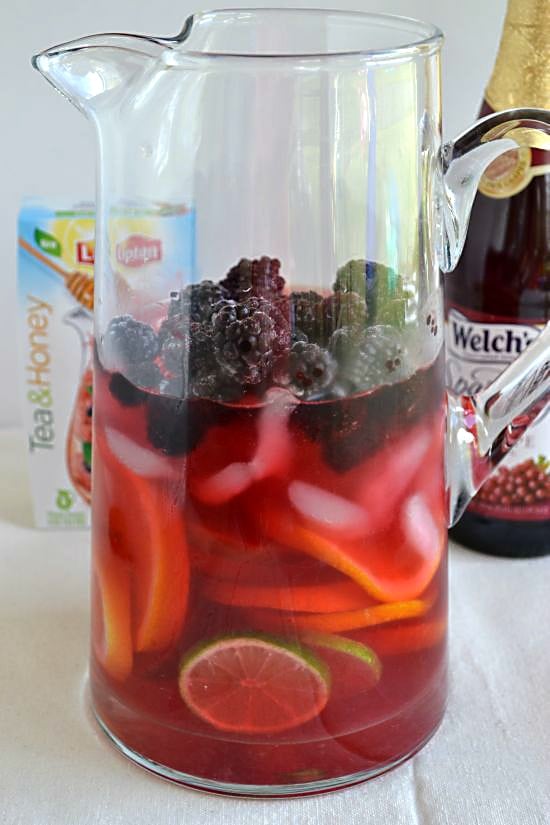  Lipton Tea Mocktail instructions add ice and frozen blackberries to the pitcher