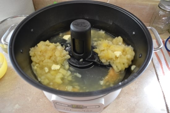 Adding pineapple to the jam maker.