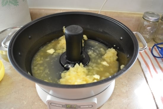 The jam maker is stirring the ingredients before heating up. 