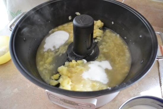 adding sugar with the jam ingredients in the automatic jelly maker.