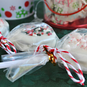 Christmas Oreo Cookie Pops wrapped in plastic for easy party favors or homemade holiday gifts.