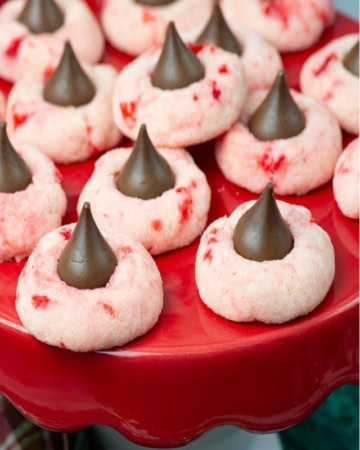 Closeup image of the cookies served on a red cake stand.