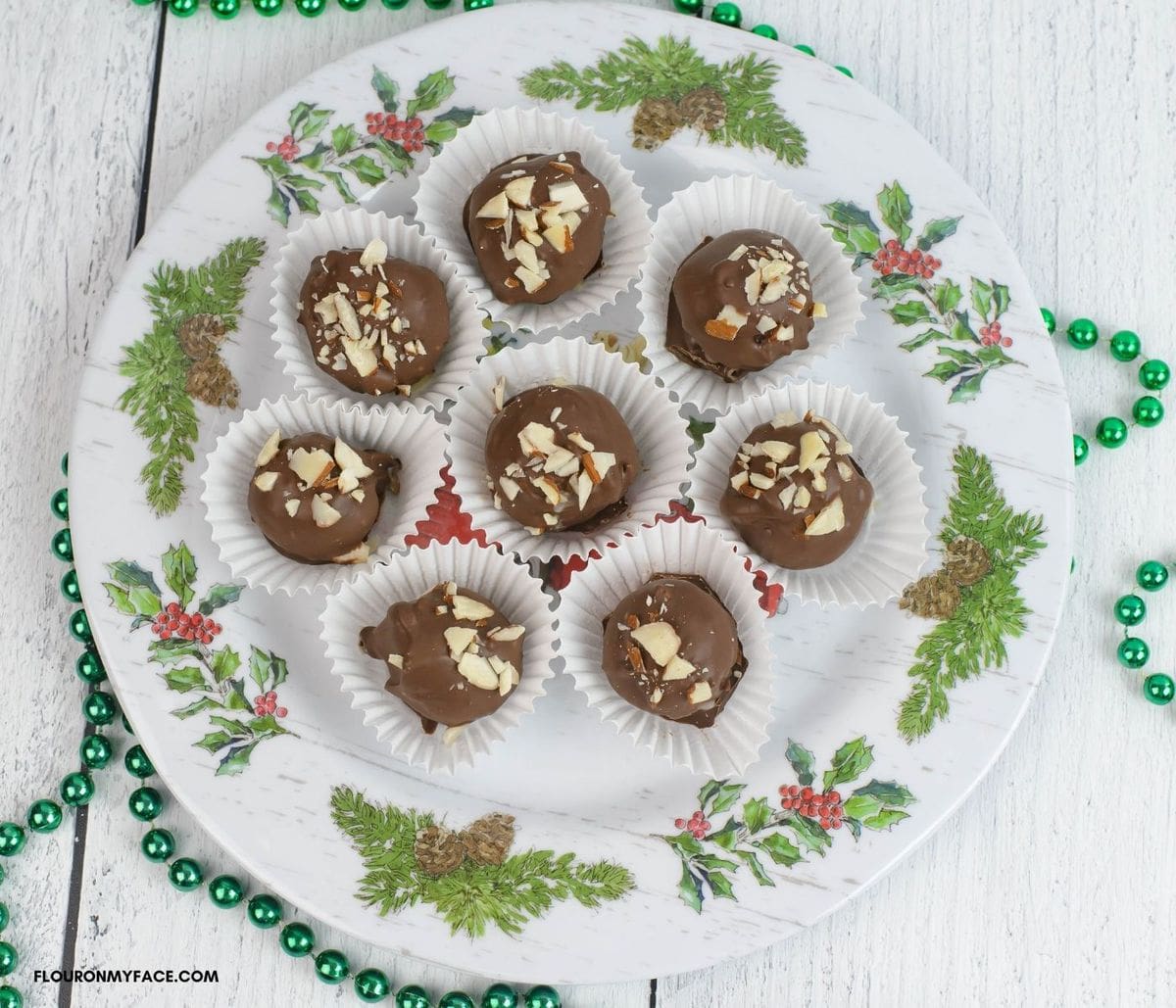 Homemade Christmas candy balls on a holiday serving plate.
