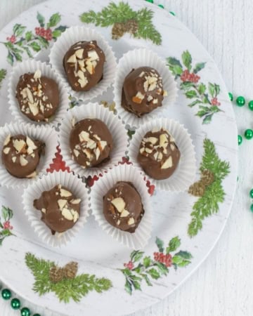 Homemade Christmas candy balls on a holiday serving plate.