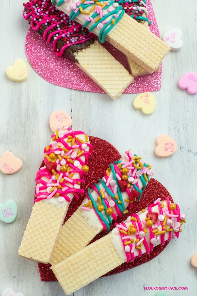 Close up of Valentines Day Chocolate dipped wafer cookies decorated with holiday sprinkles.