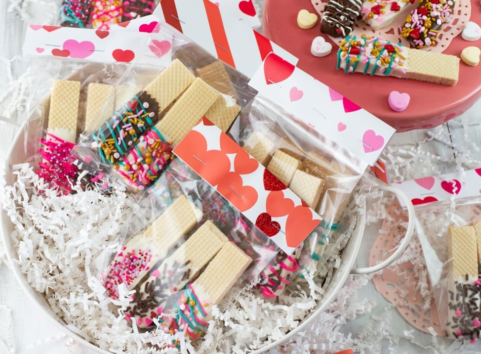 Valentines Day Chocolate Dipped Wafer Cookies in cellophane treat bags with a paper treat bag topper in a metal bucket