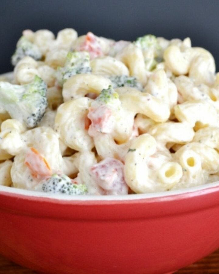 A red bowl filled with buttermilk ranch pasta salad.
