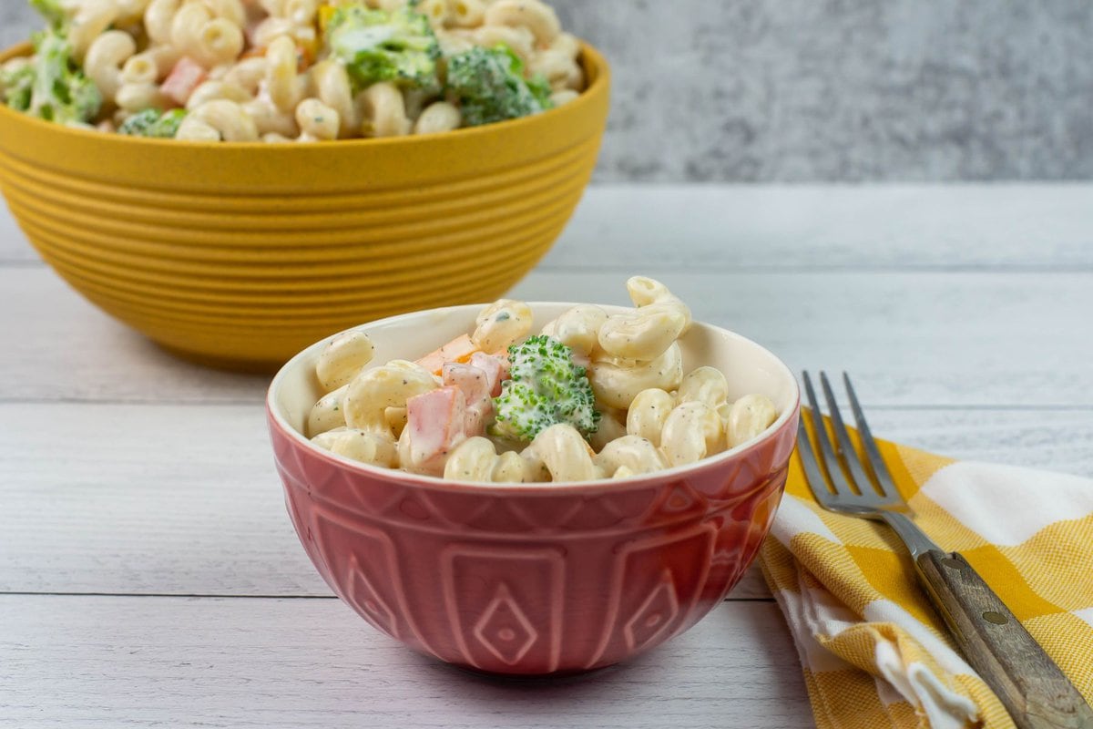 Creamy ranch pasta salad on a small red bowl.