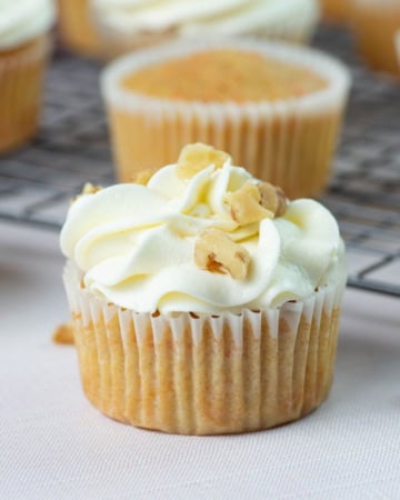 Closeup of cupcake frosted with cream cheese frosting.