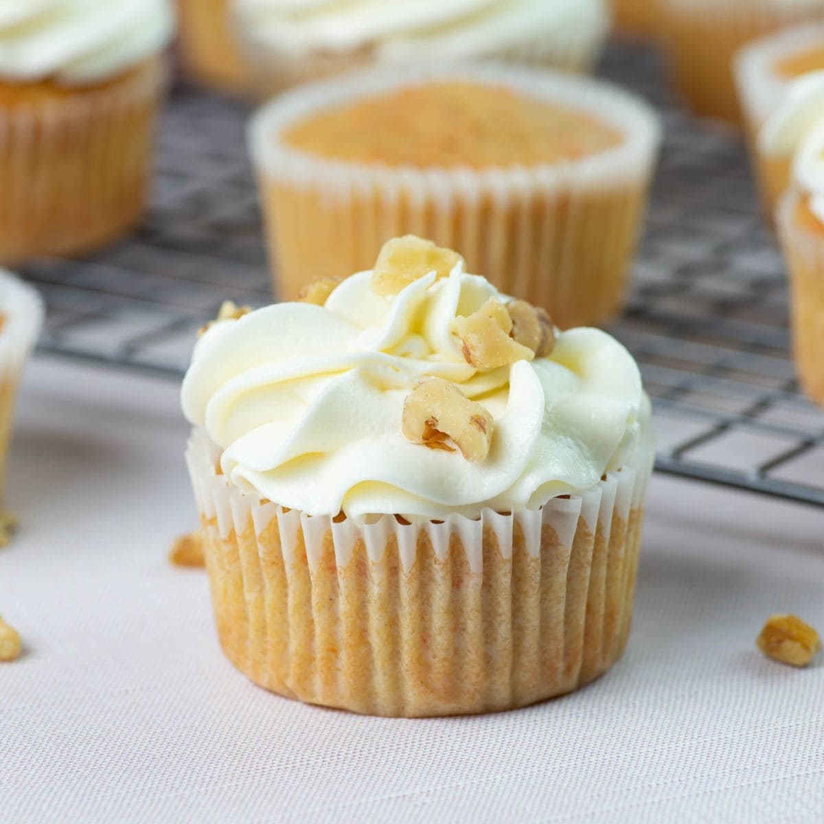 Closeup of cupcake frosted with cream cheese frosting.