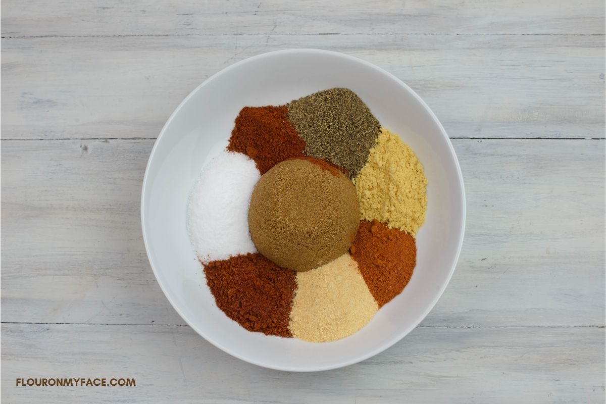 Dry pork rub spices in a white bowl.