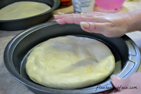 working pizza dough, forming a pizza crust, homemade deep dish pizza