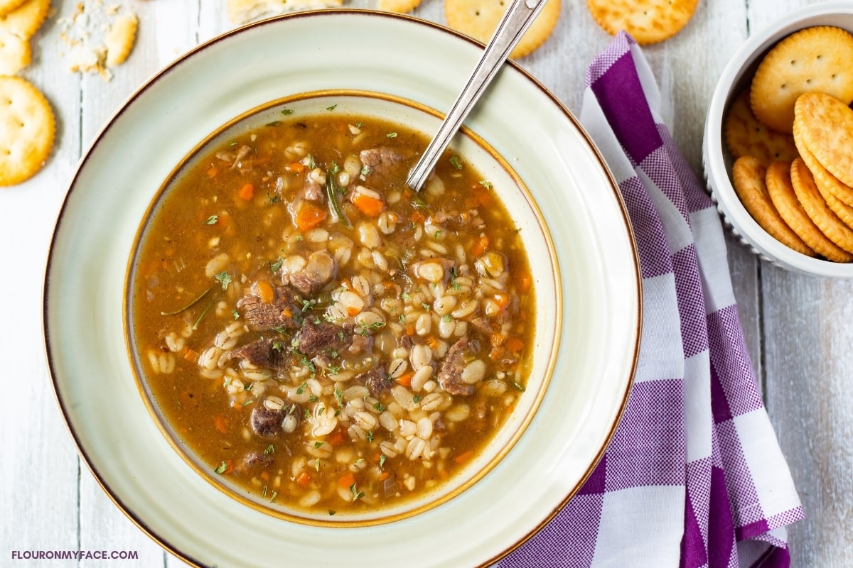 Beef Barley Soup in a bowl with a soup spoon