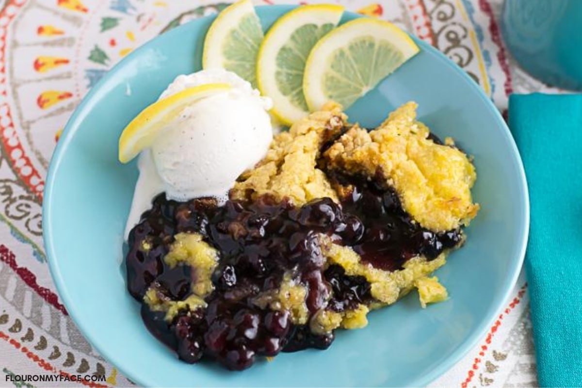 Blueberry Lemon Dump Cake served with vanilla ice cream in a dessert bowl