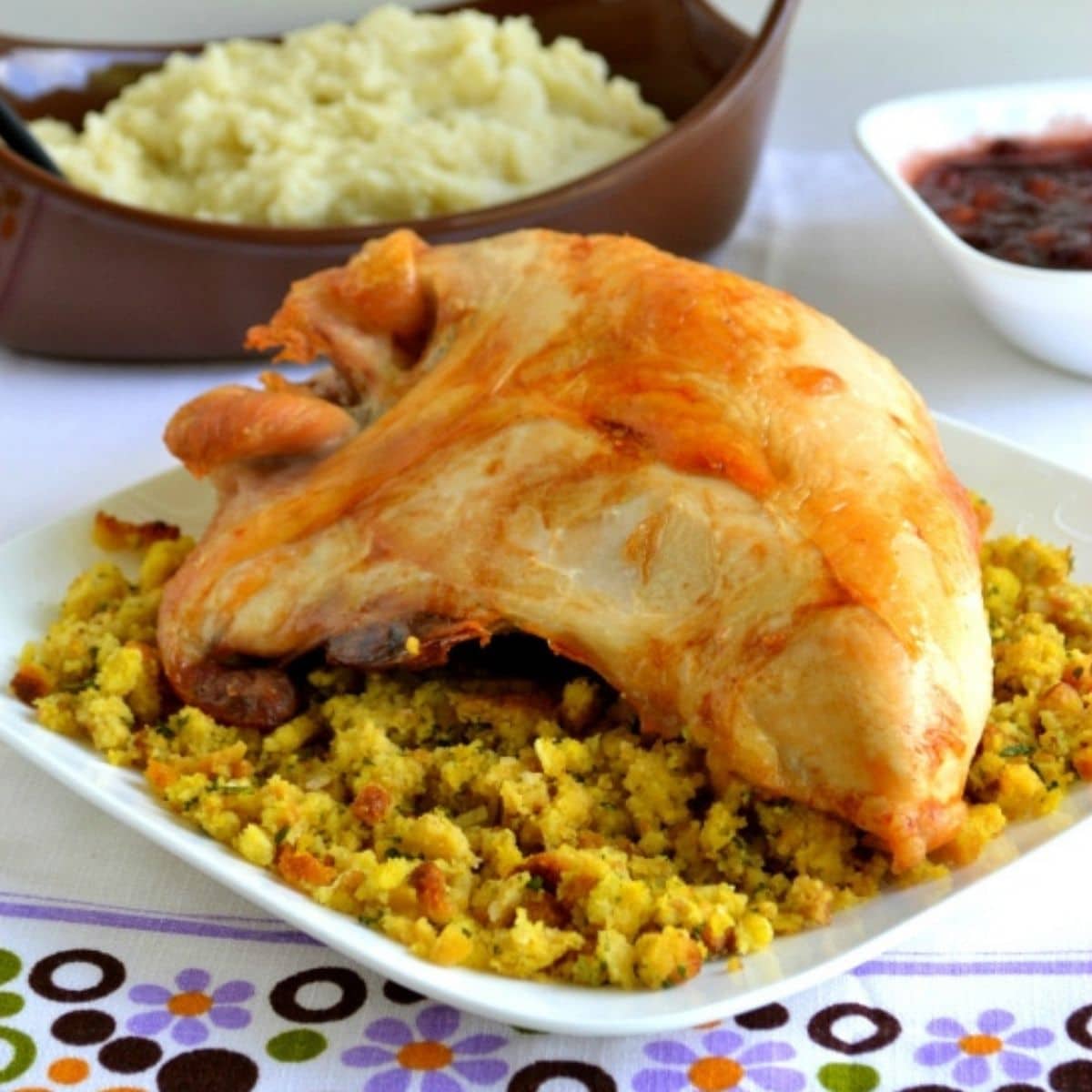 A roasted turkey breast on a bed of stuffing.