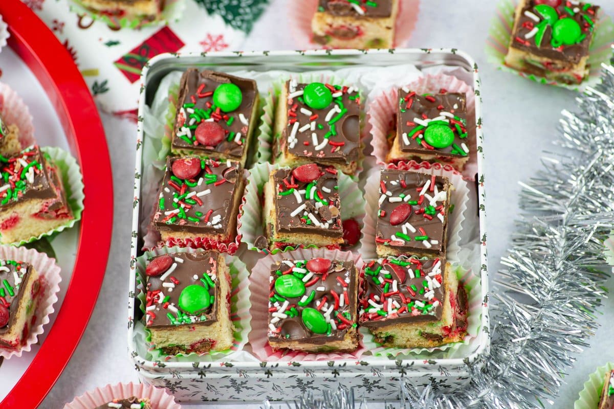 Sugar cookie bars in a holiday cookie tin for gifting.