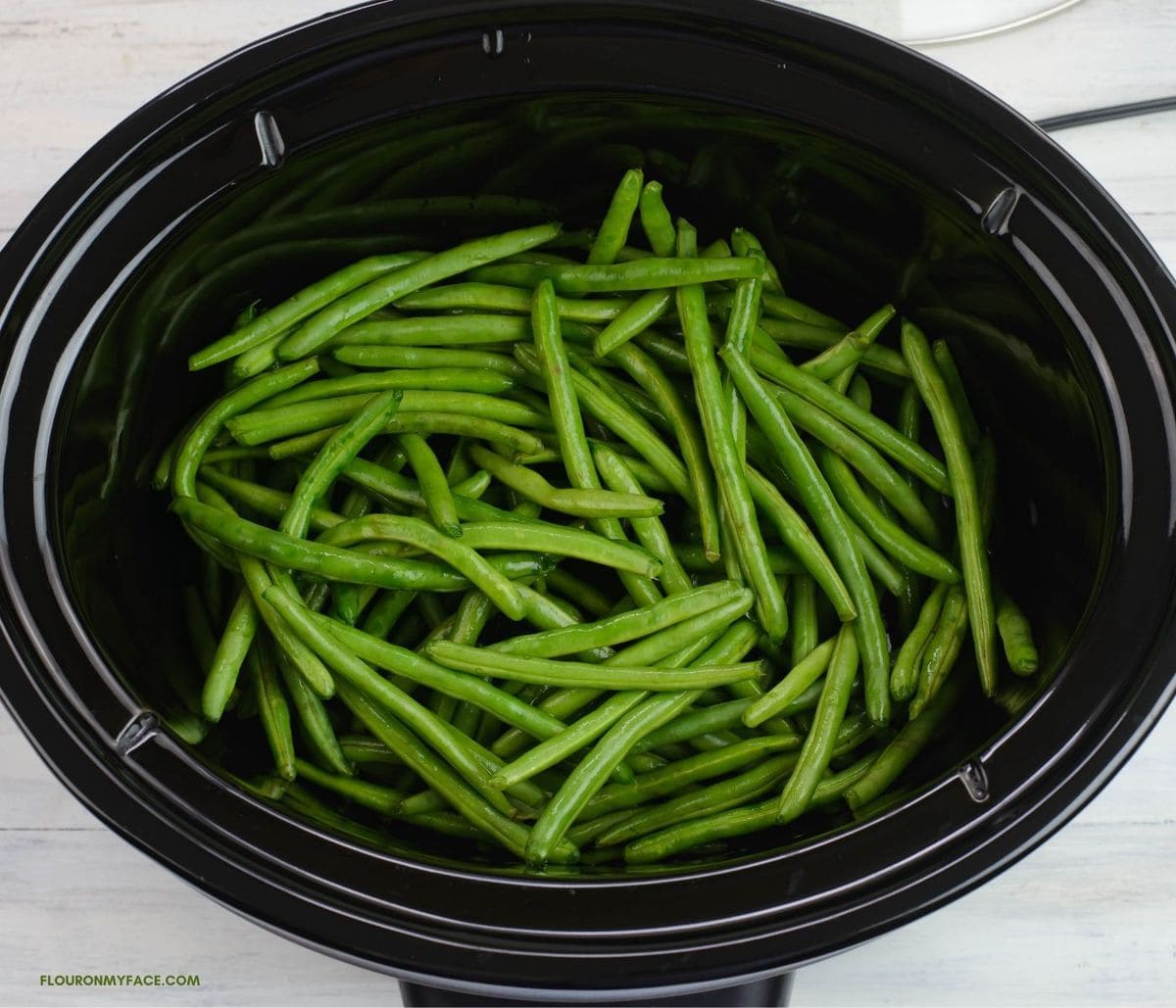Green beans inside the crockpot.