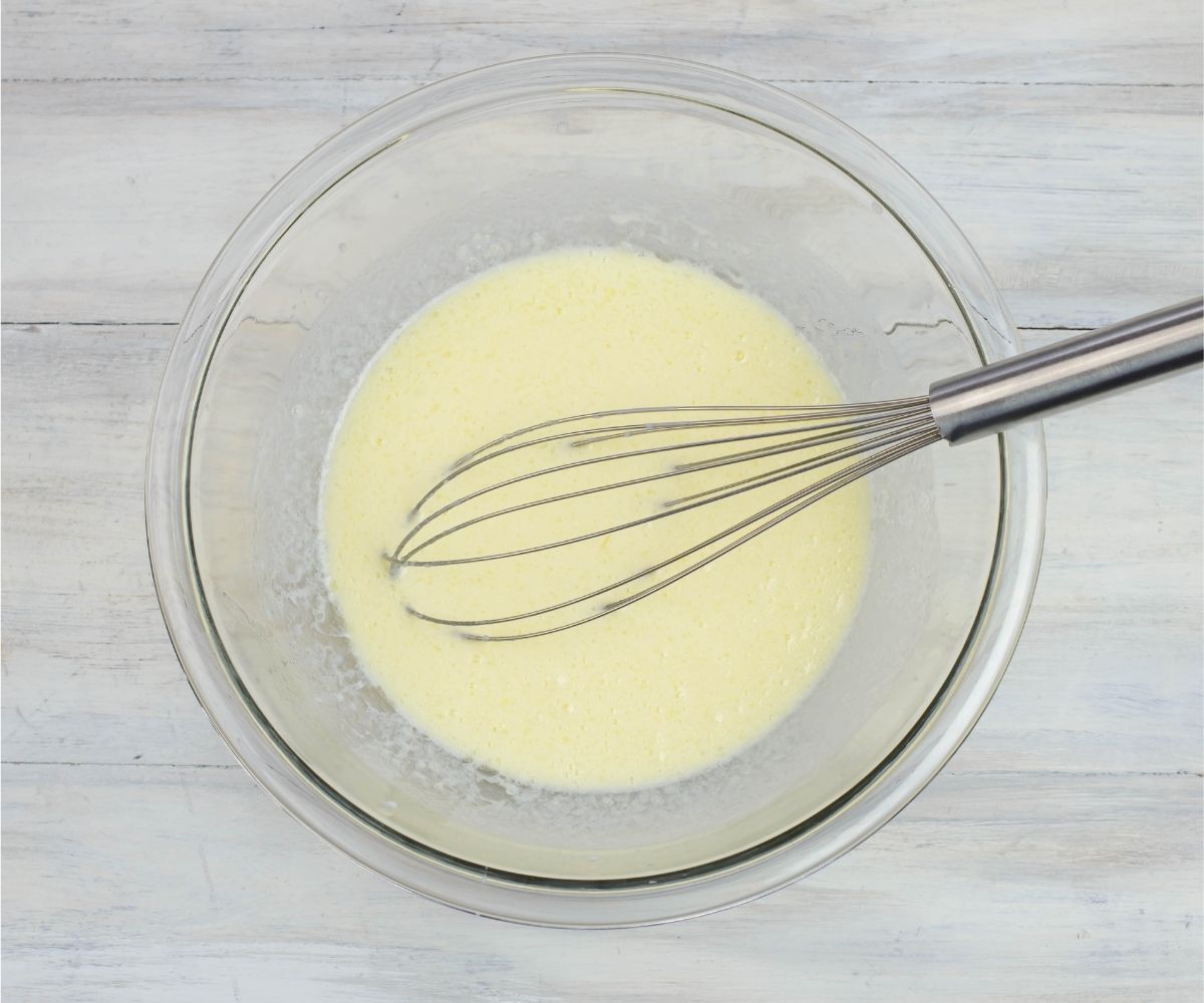 wet pancake ingredients whisked together in a bowl.