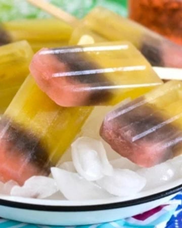 Tri colored ice pops layered on ice.
