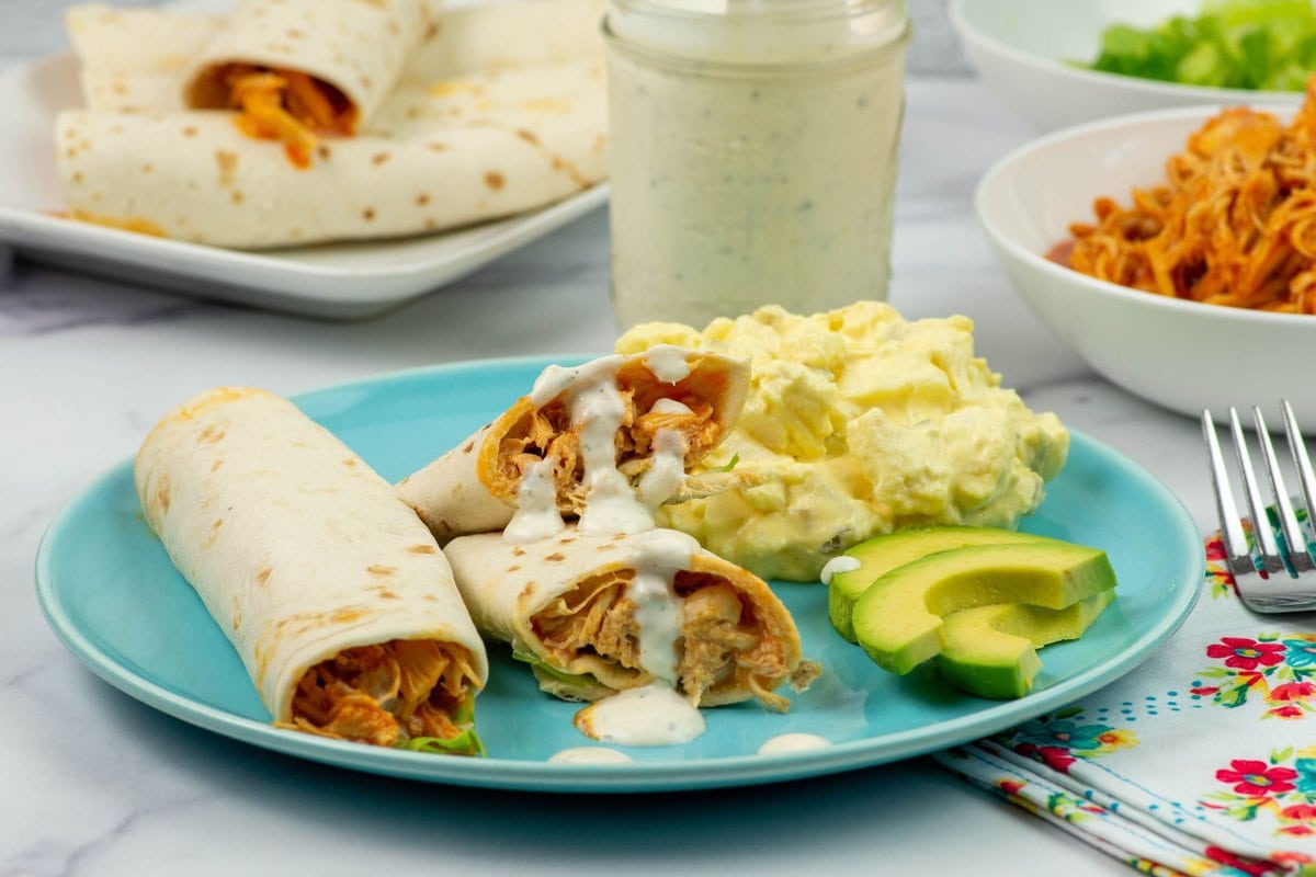Buffalo chicken wraps on a dinner plate.