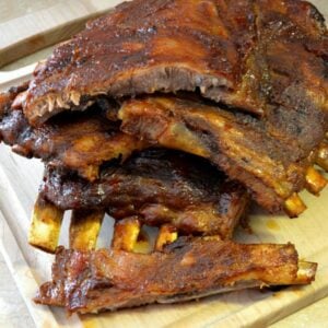 Kansas Style Pork Ribs stacked on a cutting board.