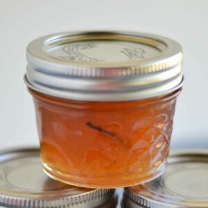 Peach Vanilla Jam in a 4 oz canning jar.